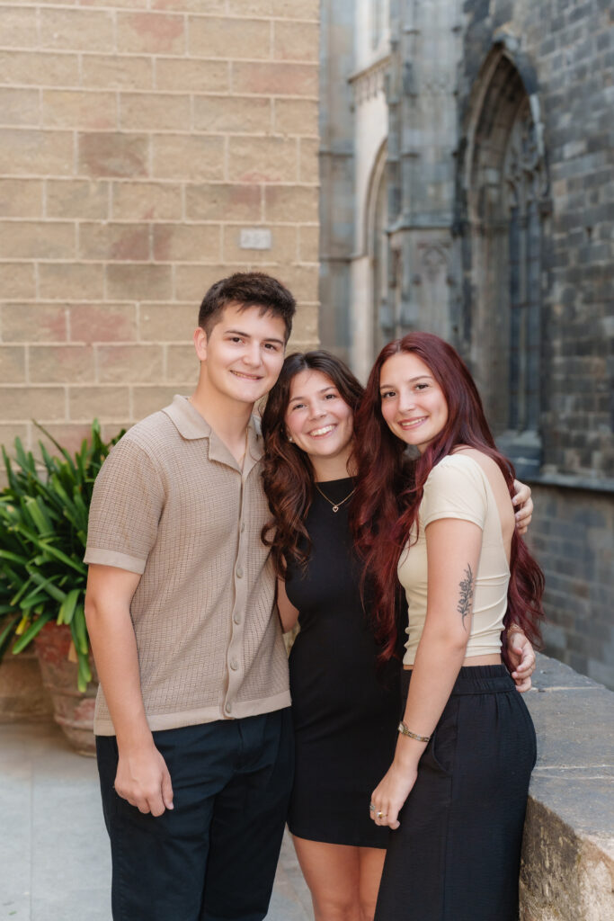 Family portrait of 3 siblings in the gothic quarter barcelona